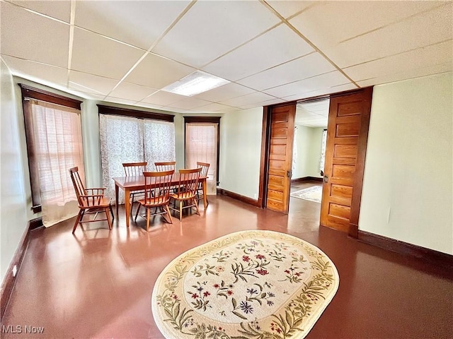 dining space with a paneled ceiling