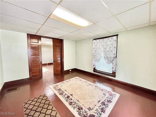 interior space featuring dark hardwood / wood-style flooring and a paneled ceiling