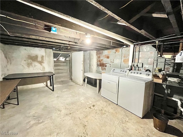 basement featuring washing machine and clothes dryer