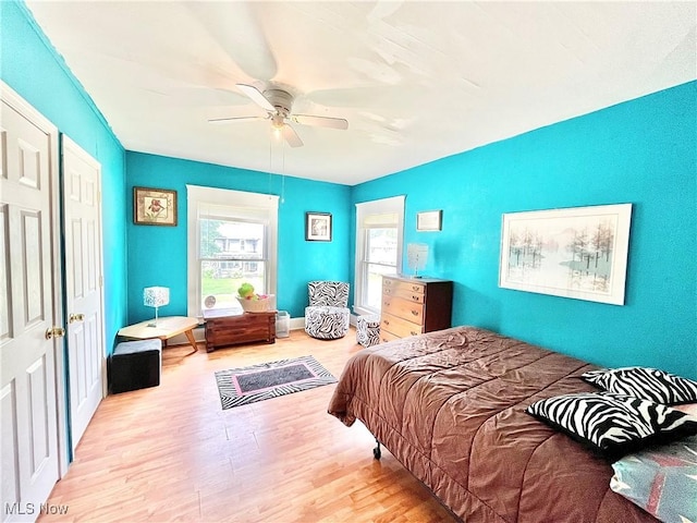 bedroom with ceiling fan and light hardwood / wood-style floors