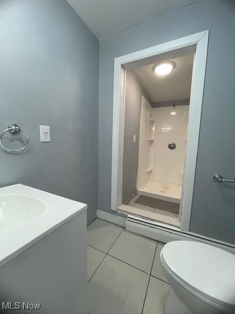 bathroom featuring toilet, vanity, tile patterned floors, and walk in shower