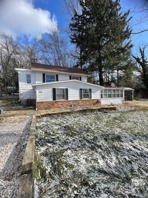 view of front of house with a sunroom