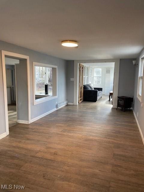 unfurnished living room featuring dark hardwood / wood-style flooring and a fireplace