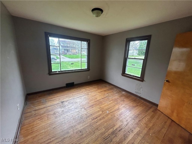 unfurnished room with light wood-type flooring