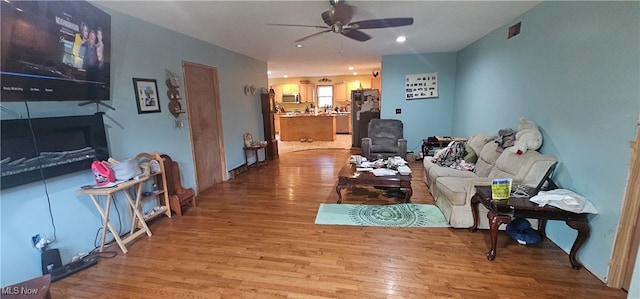 living room with ceiling fan and hardwood / wood-style floors