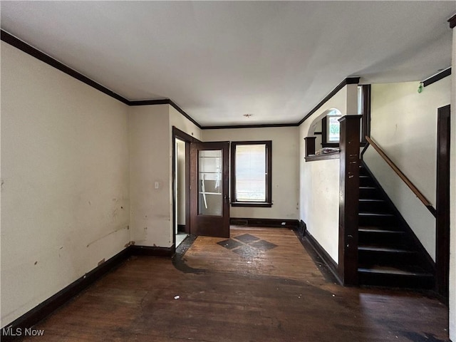 entryway featuring ornamental molding and dark wood-type flooring