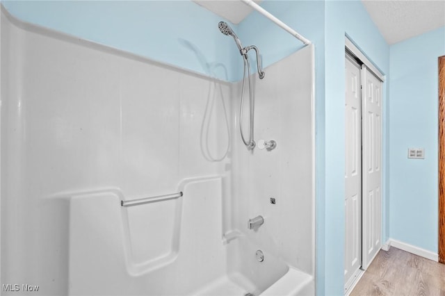 bathroom with shower / tub combination and wood-type flooring