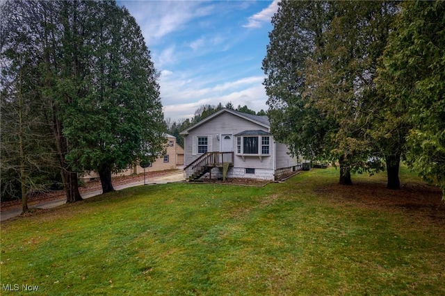 rear view of house with a yard