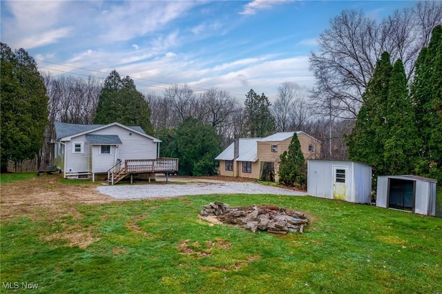 view of yard with a shed and a wooden deck