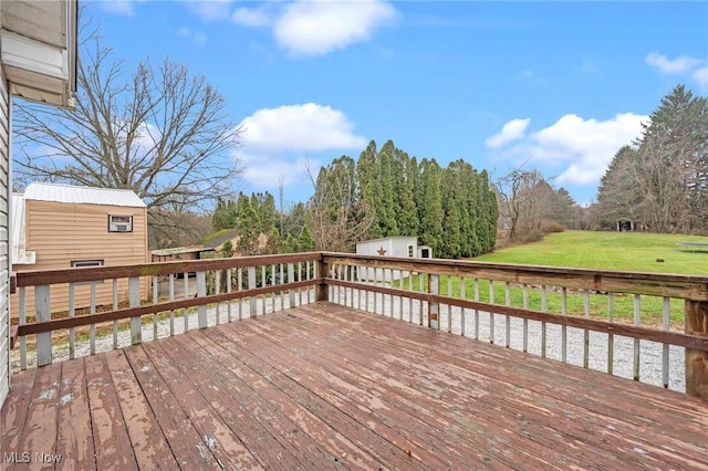 deck featuring an outdoor structure and a yard