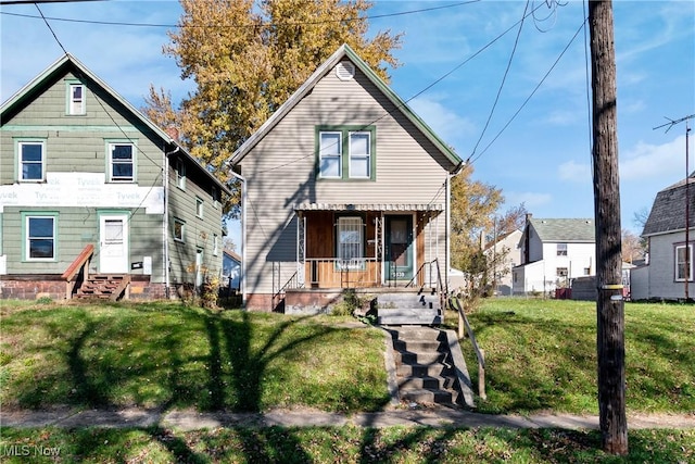 rear view of property with a lawn and a porch