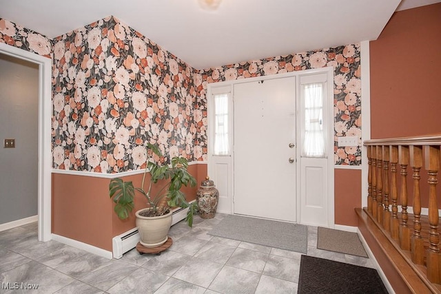 tiled foyer entrance with a baseboard heating unit