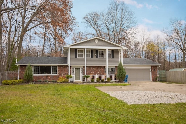 view of front of home with a front yard, a porch, and a garage