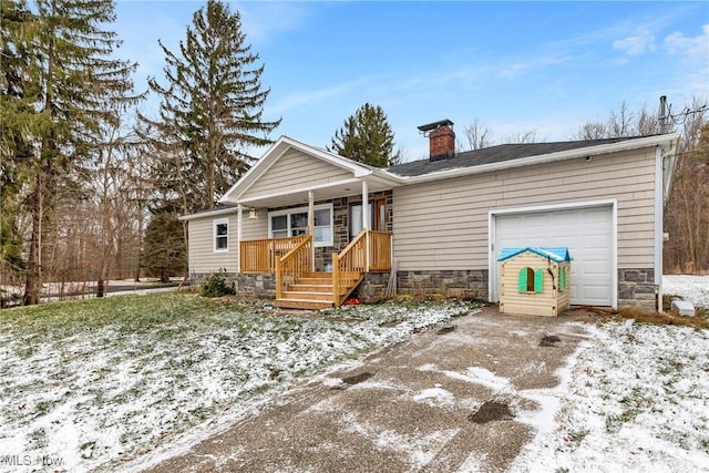 view of front of property featuring covered porch and a garage