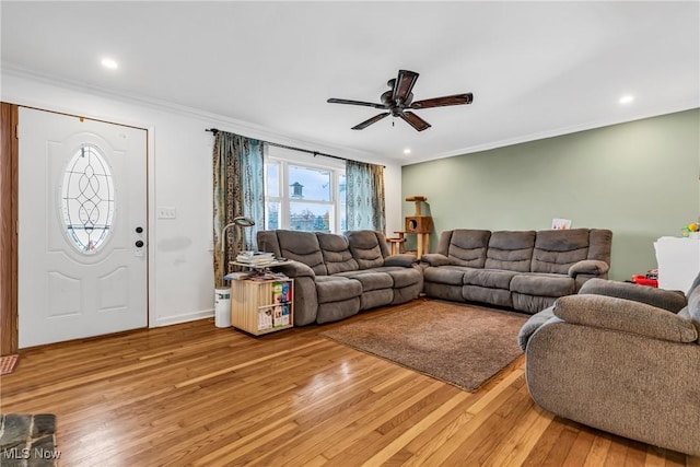 living room with ceiling fan, hardwood / wood-style floors, and ornamental molding