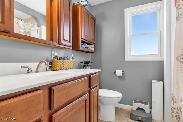 bathroom with tile patterned floors, vanity, and toilet