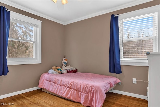 bedroom with hardwood / wood-style flooring and ornamental molding