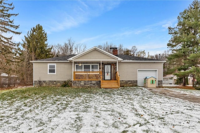 ranch-style house with covered porch and a garage