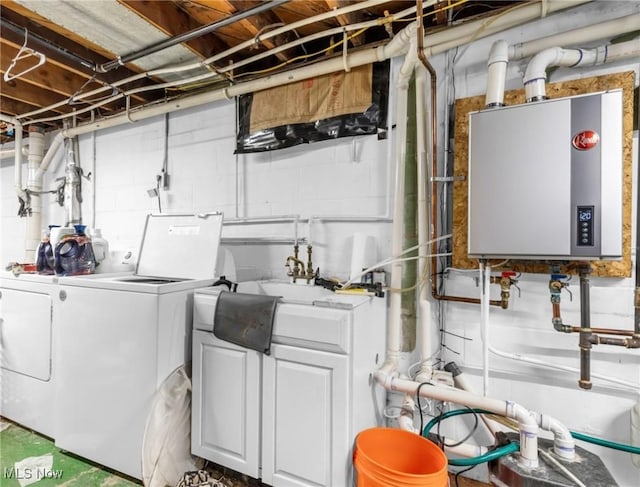 washroom with washing machine and dryer and water heater