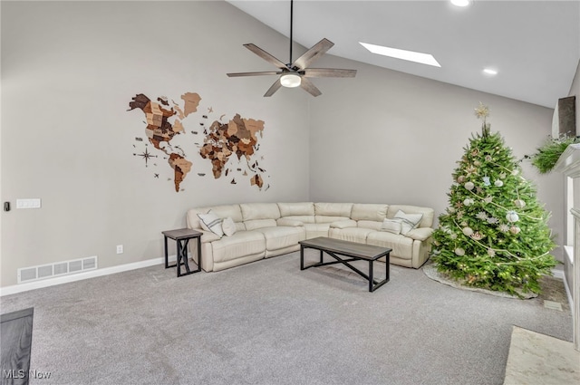 unfurnished living room with carpet floors, lofted ceiling with skylight, ceiling fan, and a premium fireplace