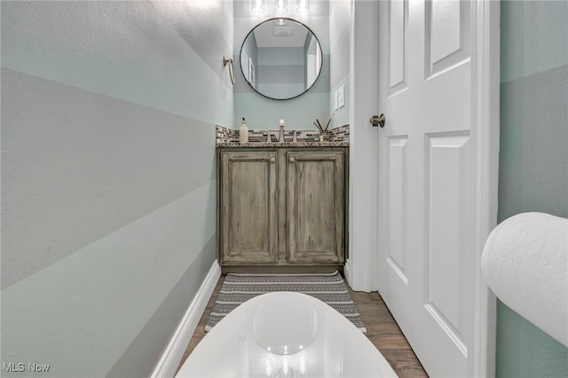 bathroom with hardwood / wood-style floors and vanity