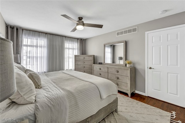 bedroom featuring ceiling fan and dark wood-type flooring