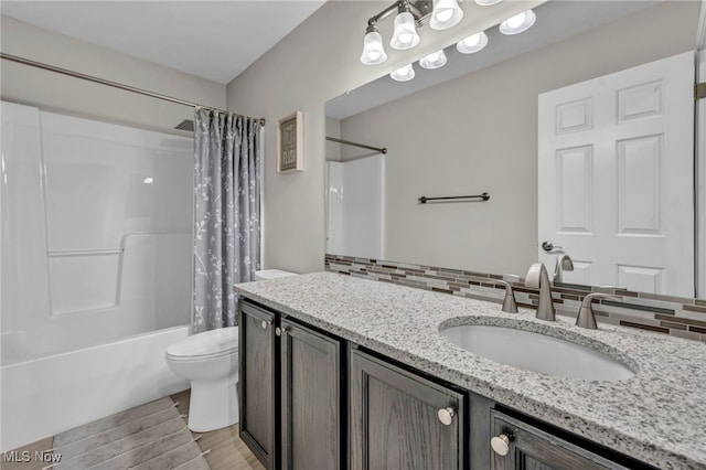 full bathroom featuring decorative backsplash, vanity, shower / bath combo with shower curtain, hardwood / wood-style flooring, and toilet