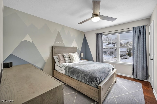 bedroom with wood-type flooring, a textured ceiling, and ceiling fan