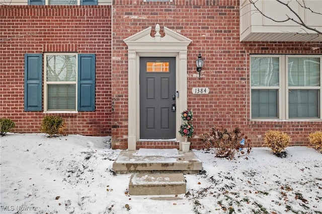 view of snow covered property entrance