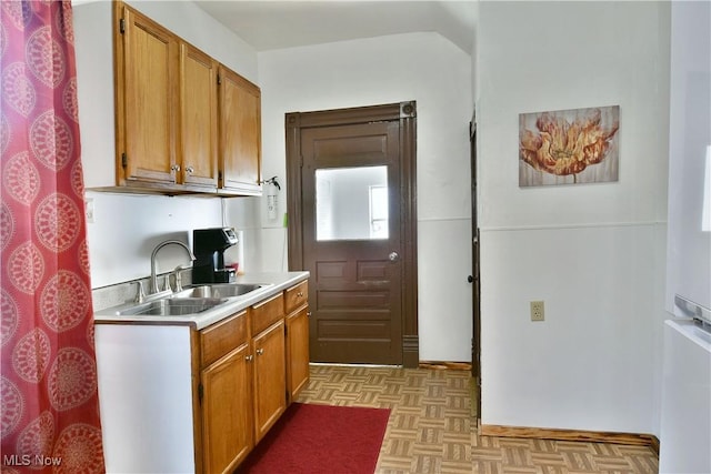 kitchen featuring sink and light parquet floors