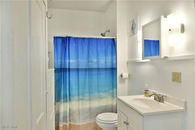 bathroom featuring vanity and toilet