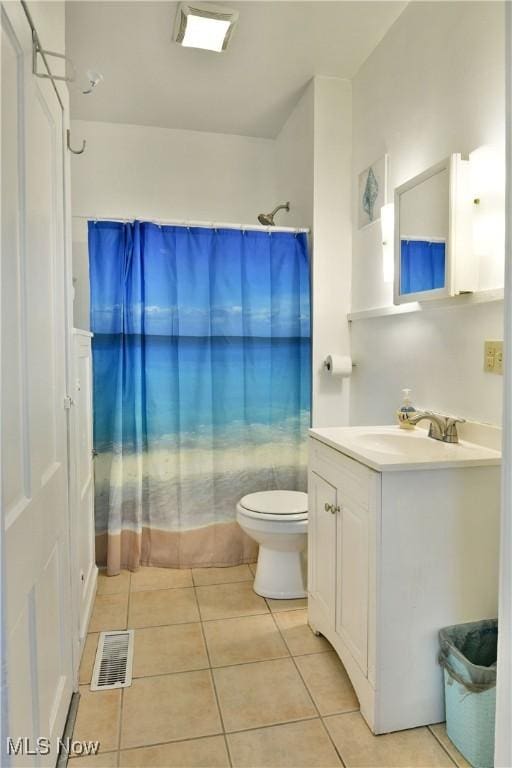 full bathroom with tile patterned floors, shower / tub combo with curtain, vanity, and toilet