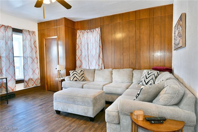 living room featuring wood walls, dark hardwood / wood-style flooring, and ceiling fan