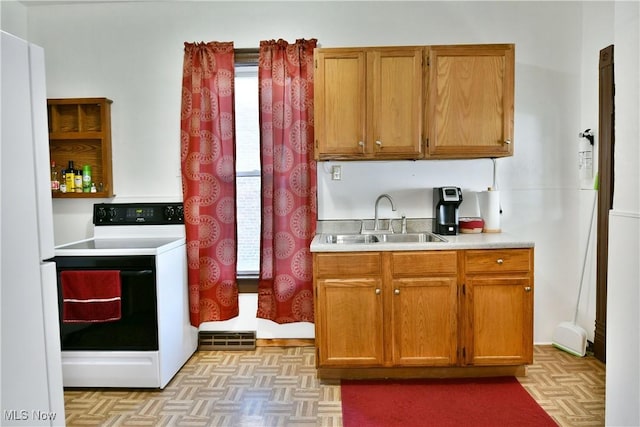 kitchen featuring white appliances, light parquet floors, and sink