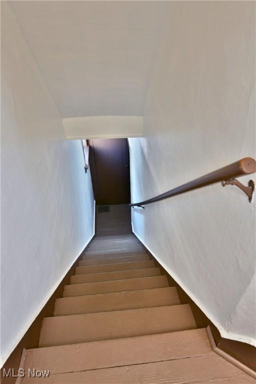 stairway with wood-type flooring