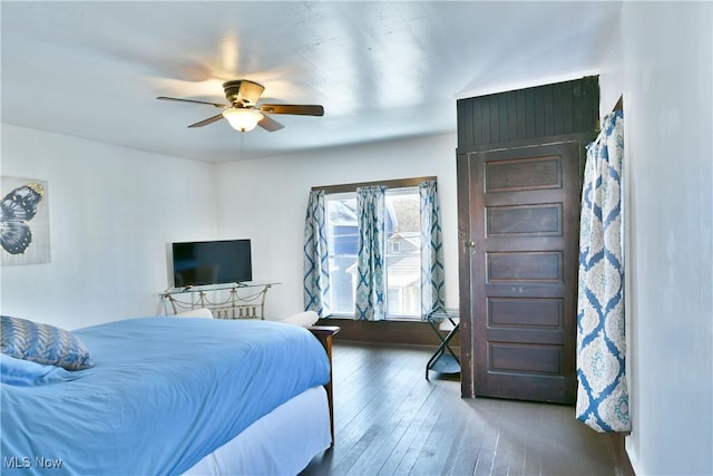 bedroom featuring ceiling fan and dark hardwood / wood-style flooring