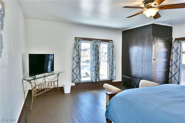 bedroom with dark hardwood / wood-style floors and ceiling fan