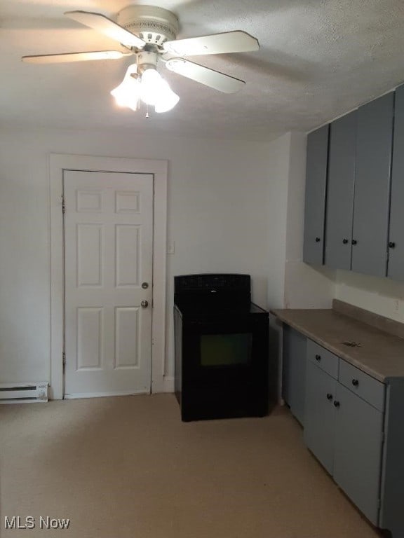 kitchen featuring a baseboard heating unit, black range, ceiling fan, a textured ceiling, and light colored carpet