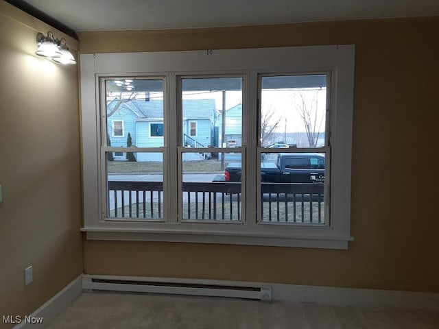 interior space with plenty of natural light and a baseboard heating unit