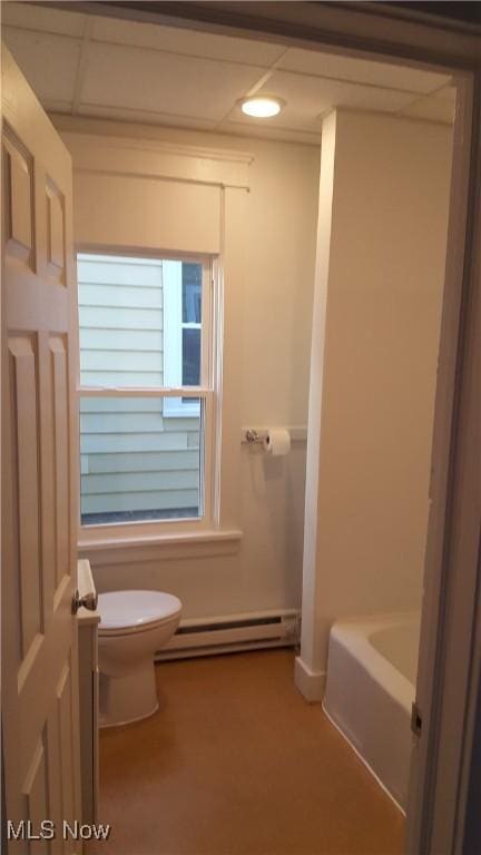 bathroom with a washtub, a baseboard radiator, and toilet