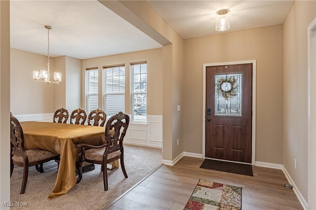 dining space featuring hardwood / wood-style floors and a notable chandelier