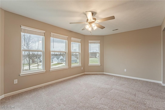 unfurnished room with ceiling fan and carpet floors