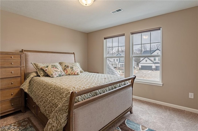 bedroom featuring carpet flooring and multiple windows