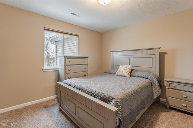 carpeted bedroom featuring a textured ceiling