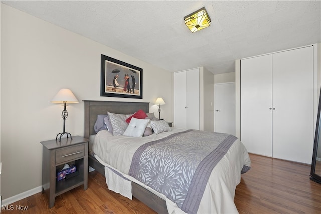 bedroom featuring hardwood / wood-style floors and a textured ceiling