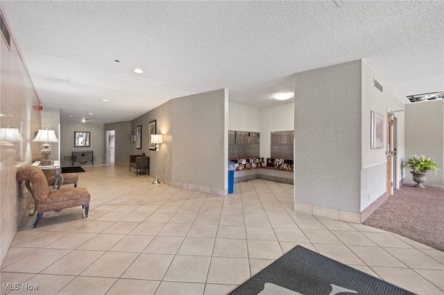 interior space with light tile patterned floors and a textured ceiling