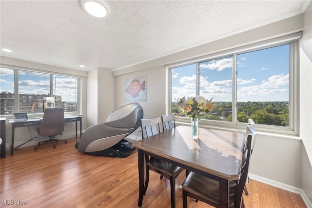 dining area featuring hardwood / wood-style floors and a textured ceiling