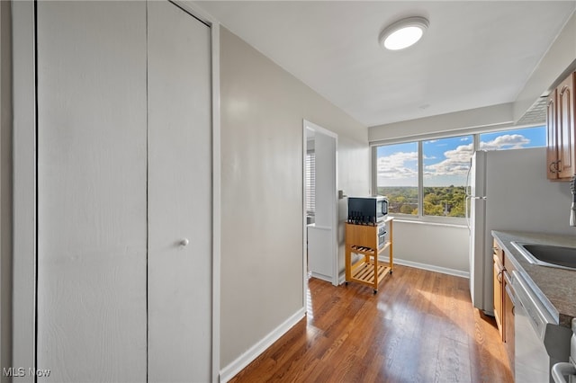 kitchen with white dishwasher and light hardwood / wood-style flooring