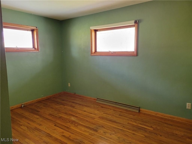 spare room featuring wood-type flooring