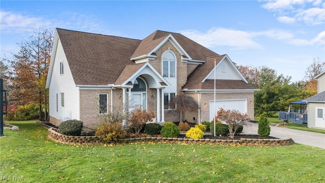 view of property featuring a front yard and a garage